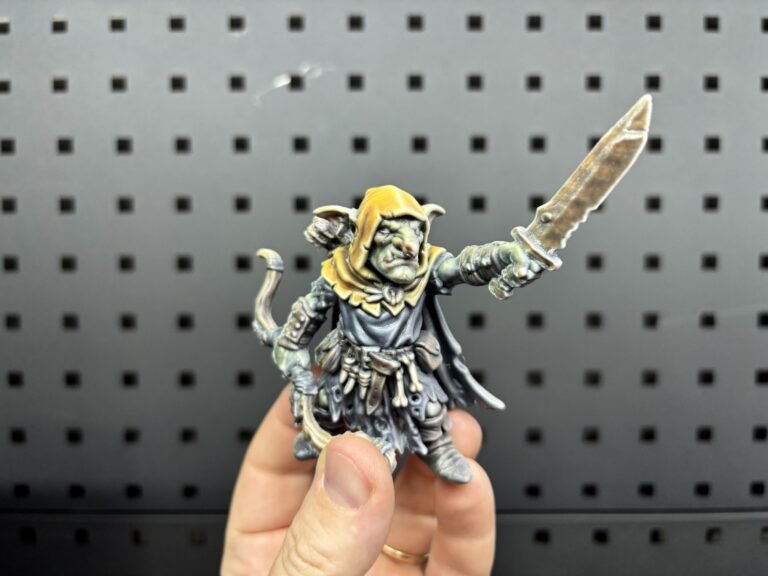 Full-colour 3D printed goblin archer miniature holding a blade