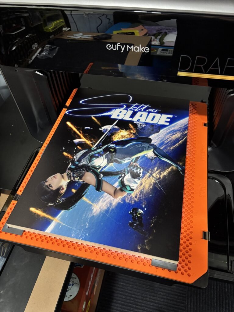 Full-colour game poster being UV printed onto a wood panel on the eufyMake E1